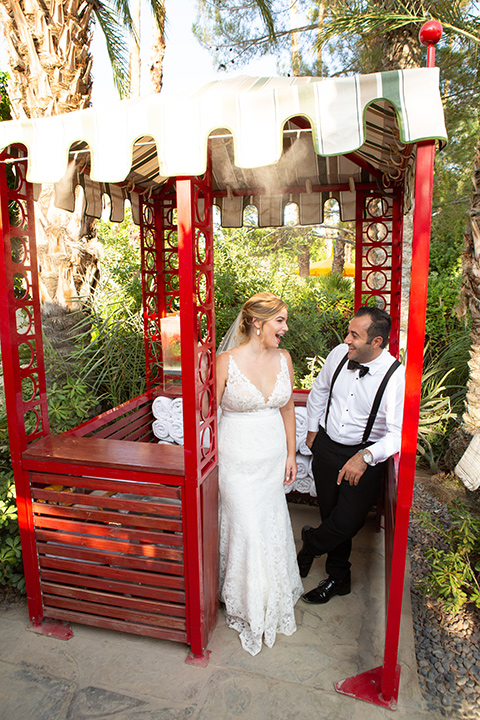 Palm-Springs-wedding-at-the-parker-bride-and-groom-in-fun-outdoor-decor-bride-alone-in-a-flowing-gown-and-a-deep-v-neckline