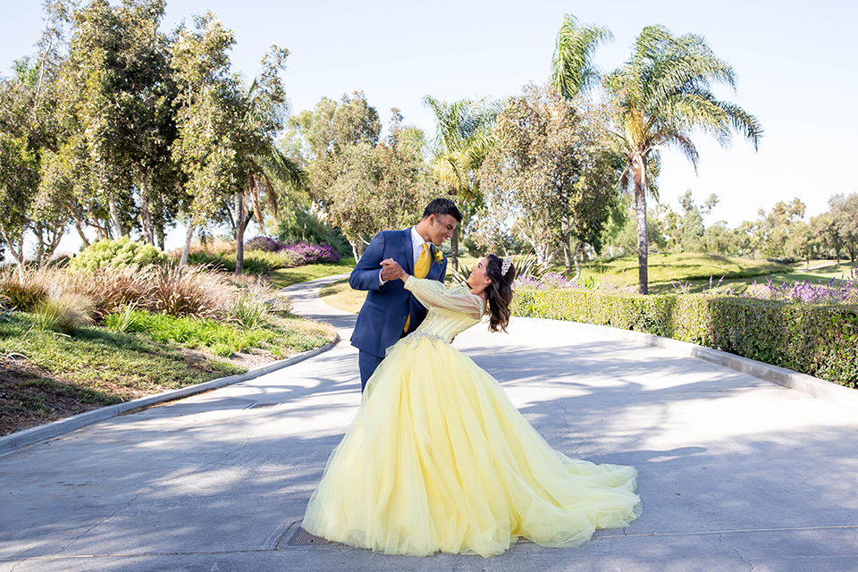 quince-shoot-birthday-girl-in-yellow-dress-chambelan-in-royal-blue-suit-in-a-beauty-and-the-beast-inspired-quince