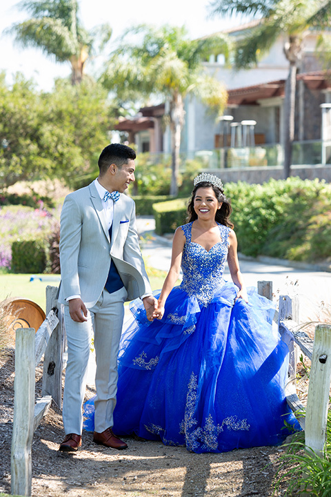 quince-shoot-blue-and-grey-color-scheme-with-girl-in-a-lue-gown-with-a-cap-sleeve-chambelan-in-a-grey-suit-with-blue-acessories