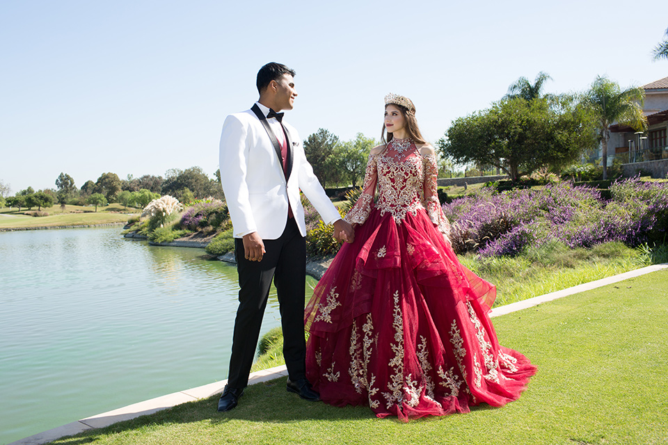 quince-shoot-burgundy-black-and-white-color-scheme-bithday-girl-wearing-a-burgundy-gown-with-sleeves-and-boy-wearing-a-white-tuxedo=with-black-trim-and-a-burgundy-vest