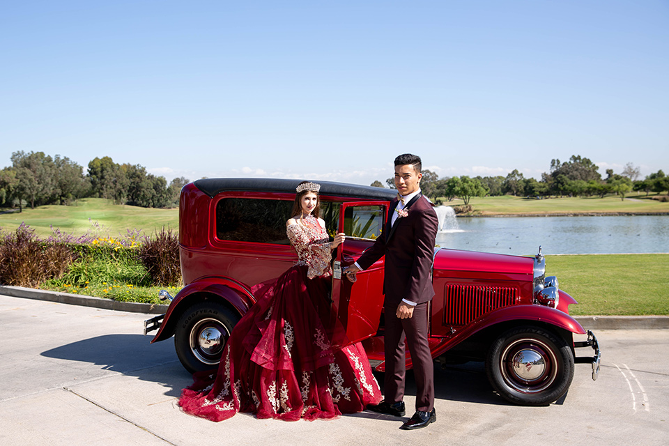 quince-shoot-royal-themed-attire-birthday-girl-in-a-burgundy-dress-chambelan-in-a-deep-burgundy-tuxedo-with-gold-accessories