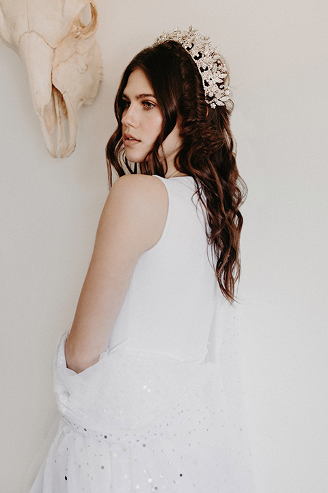 Rim-Rock-Ranch-Shoot-bride-with-crown-on-and-a-sheer-bohemian-dress-with-crsystals-and-flutter-sleeves