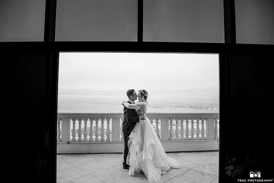 Hyatt-San-Diego-wedding-bride-and-groom-in-black-and-white-phooto-the-bride-is-in-a-blush-toned-ballgown-and-the-groom-in-a-black-shawl-lapel-tuxedo