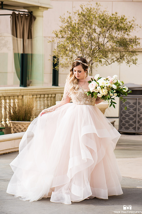 Hyatt-San-Diego-wedding-bride-looking-at-gown