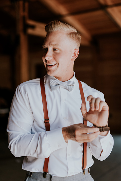 serendiity-gardens-groom-with-suspenders-alone-groom-in-a-grey-suit-with-brown-suspenders