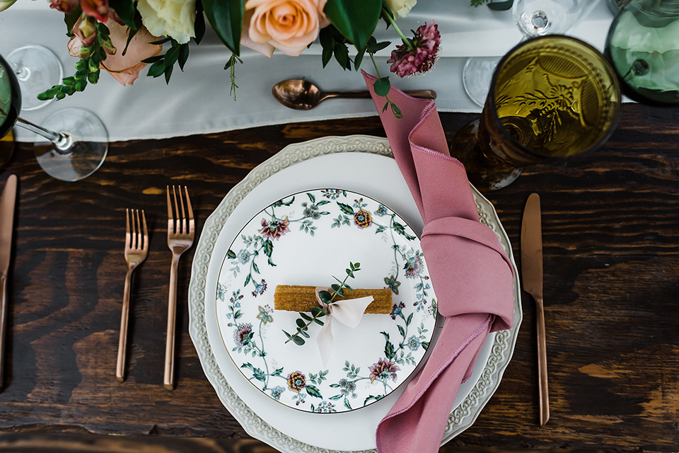 Olivas-Adobe-spanish-inspired-shoot-table-placement-with-pink-napkins-and-white-table-linens-and-gold-silverware