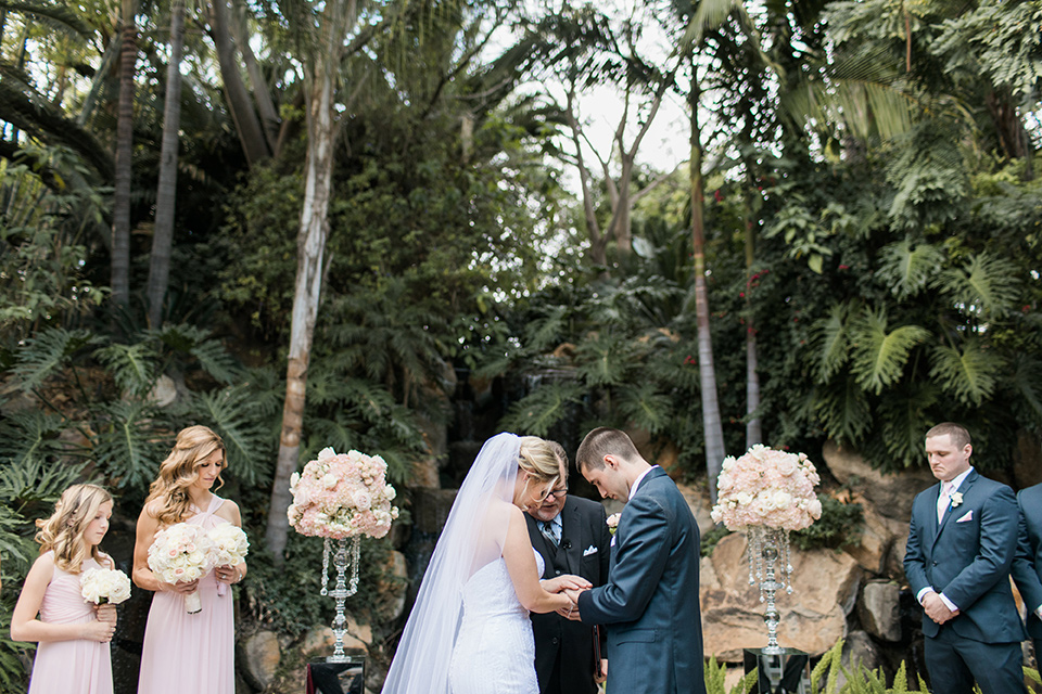 ceremony-bowing-heads-the-bridesmaids-in-pink-long-gowns-groomsmen-in-blue-suits-the-bride-was-in-a-trumpet-style-gown-with-a-strapless-neckline-and-the-groom-is-a-navy-suit-with-ivory-tie