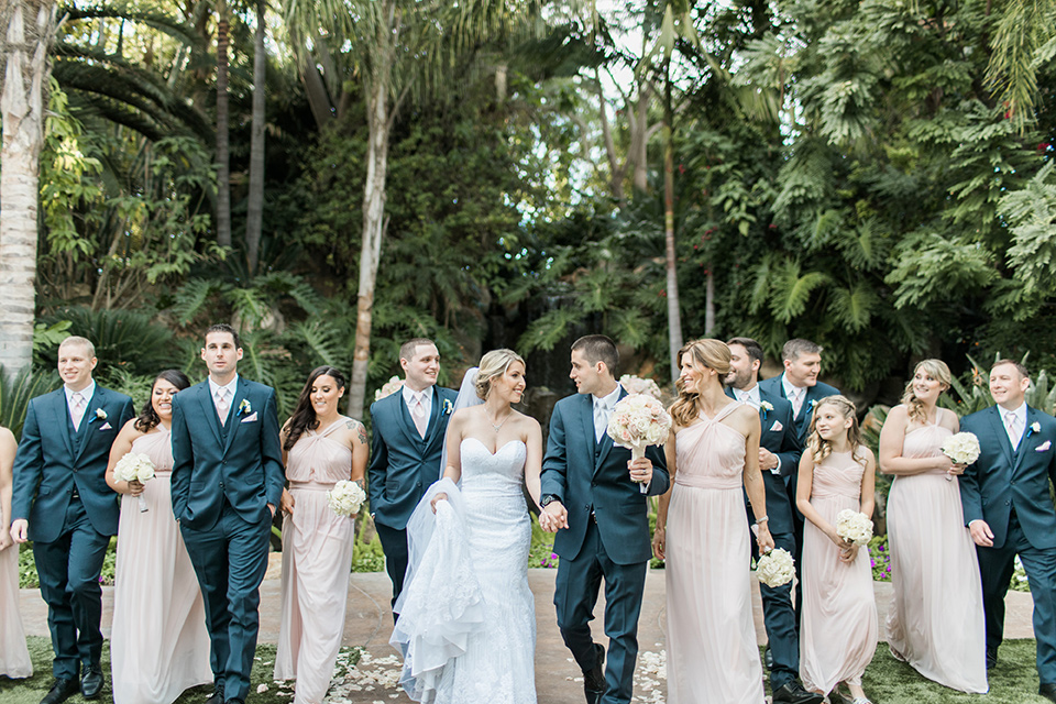 tropical-wedding-at-the-grand-tradition-bridalparty-the-bridesmaids-in-pink-long-gowns-groomsmen-in-blue-suits-the-bride-was-in-a-trumpet-style-gown-with-a-strapless-neckline-and-the-groom-is-a-navy-suit-with-ivory-tie