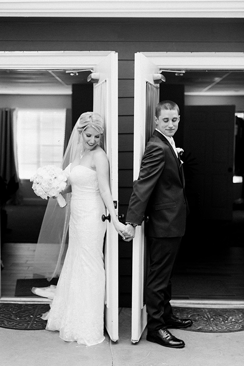 tropical-wedding-at-the-grand-tradition-bride-and-groom-backs-turned-to-eachother-the-bride-in-a-trumpet-style-gown-with-a-stapless-neckline-and-the-groom-in-a-navy-suit-with-an-ivory-tie