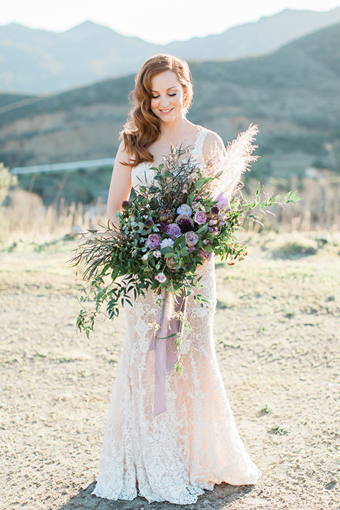 triunfo-creek-vineyards-wedding-bride-alone-wearing-a-flowing-ivory-and-blush-gown-with-straps-and-a-sweetheart-neckline