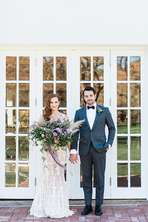 triunfo-creek-vineyards-wedding-bride-and-groom-standing-facing-camera-bride-in-a-flowing-gown-with-a-tulle-skirt-and-straps-groom-in-a-dark-grey-tuxedo