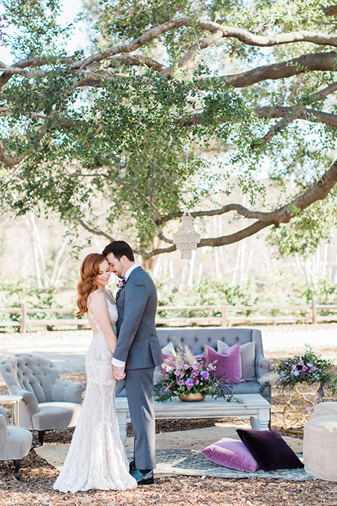 triunfo-creek-vineyards-wedding-couple-by-outdoor-furniture-bride-in-a-flowing-gown-with-a-tulle-skirt-and-straps-groom-in-a-dark-grey-tuxedo