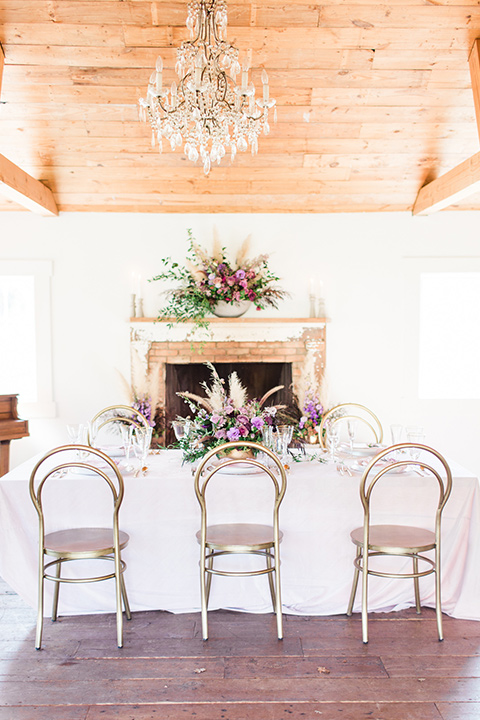 triunfo-creek-vineyards-wedding-table-and-chairs-with-white-linens-and-purple-and-gold-decor