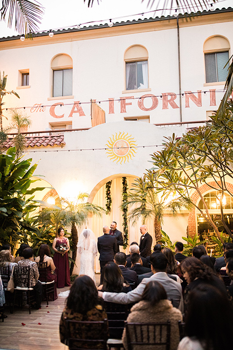 villa-del-sol-wedding-ceremony-in-a-spanish-inspired-ceremony-space-with-greenery