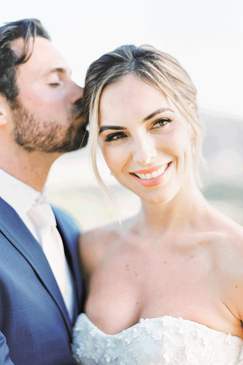 whispering-rose-shoot-bride-and-groom-close-bride-wearing-a-strapless-gown-with-pink-shoes-groom-in-a-cobalt-blue-suit-with-brown-shoes-and-an-ivory-tie