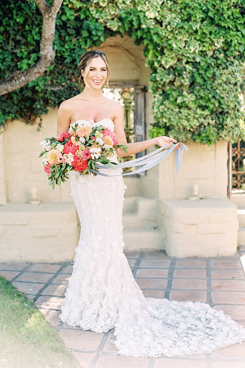 whispering-rose-shoot-bride-standing-alone-bride-wearing-a-strapless-gown-with-pink-shoes