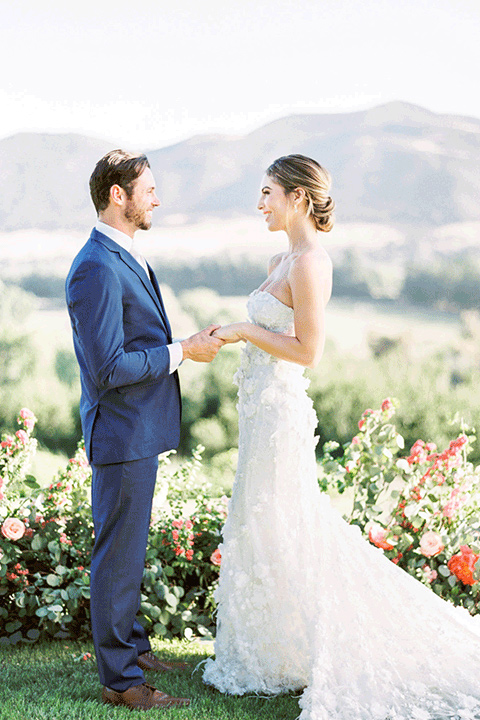 whispering-rose-shoot-ceremony-bride-wearing-a-strapless-gown-with-pink-shoes-groom-in-a-cobalt-blue-suit-with-brown-shoes-and-an-ivory-tie