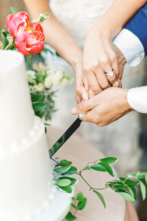 whispering-rose-shoot-cutting-the-cake-bride-wearing-a-strapless-gown-with-pink-shoes-groom-in-a-cobalt-blue-suit-with-brown-shoes-and-an-ivory-tie