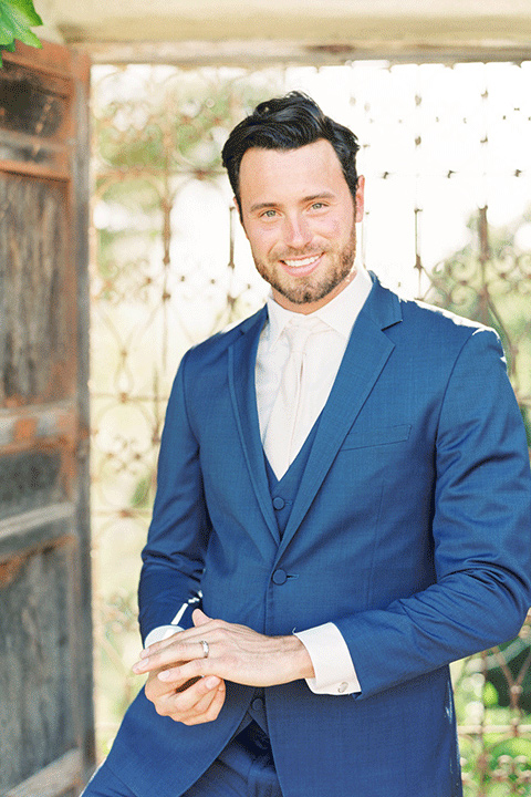 whispering-rose-shoot-groom-alone-groom-in-a-cobalt-blue-suit-with-brown-shoes-and-an-ivory-tie