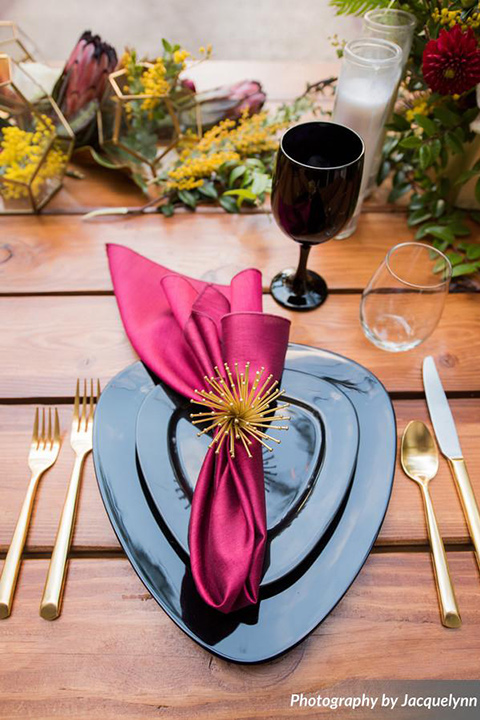  farmhouse tables with black flatware and gold utensils