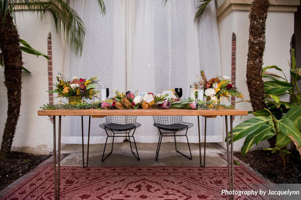  farmhouse table with colorful florals and tall candles