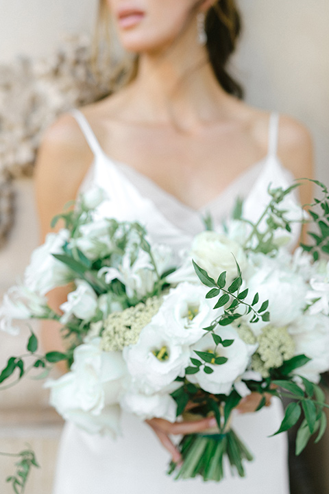  bride in a satin formfitting gown with thin straps 