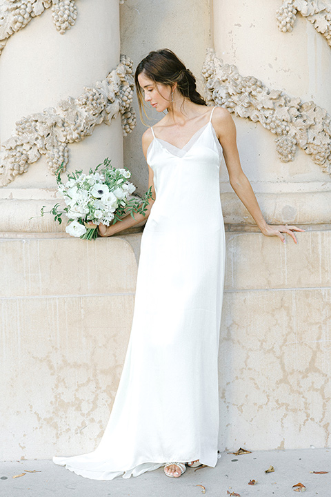  bride in a satin formfitting gown with thin straps