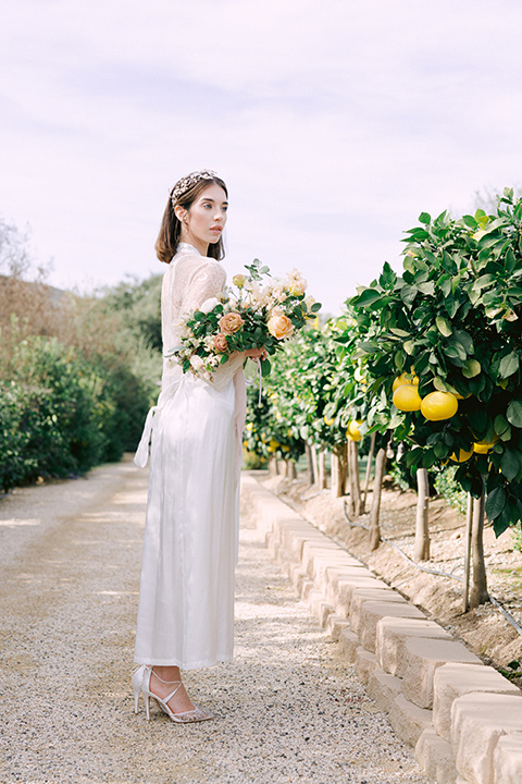  bride in vineyard with florals 