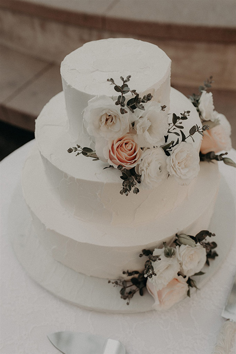  white cake with whte and pink floral design