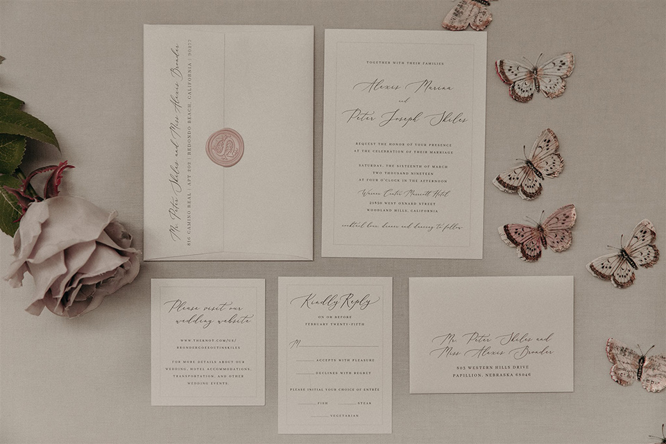  white invitations and mauve colored cursive