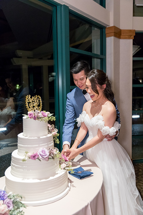  white cake with pink and lilac flowers 