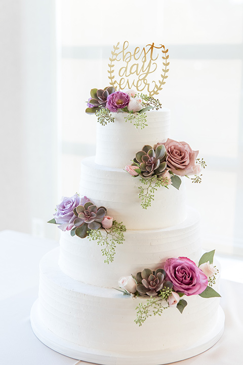  white cake with pink and lilac flowers