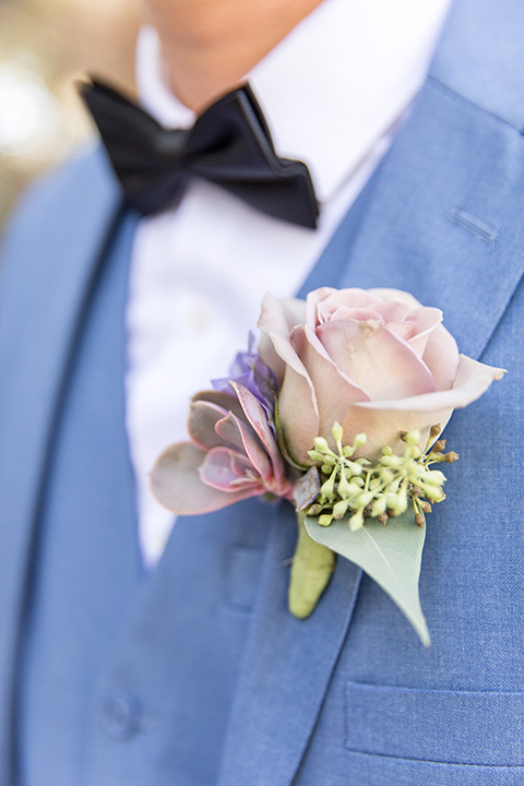  light blue notch lapel suit with a navy bow tie 