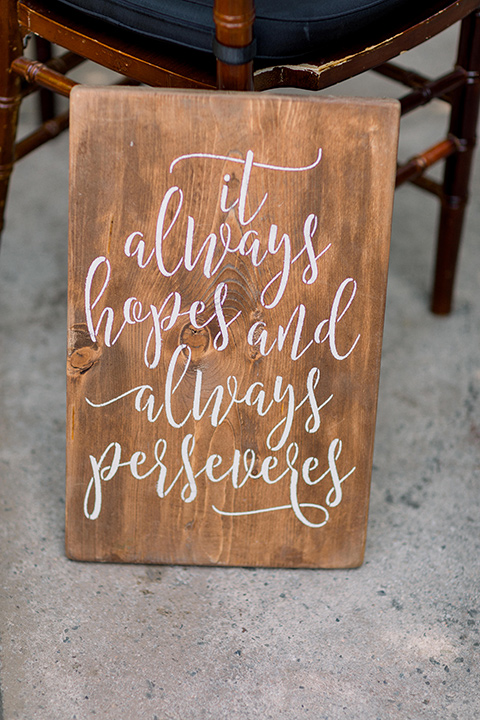  wooden sign welcoming everyone to the wedding