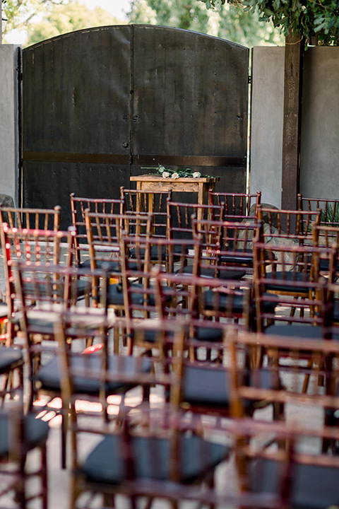  deep brown wooden chairs at the ceremony