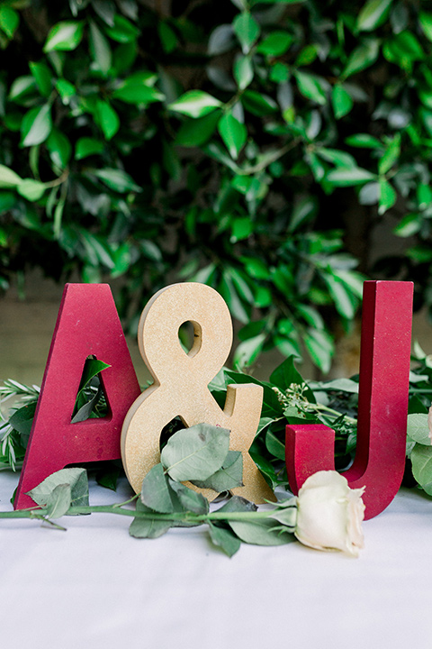  gold and red initials on sweetheart table