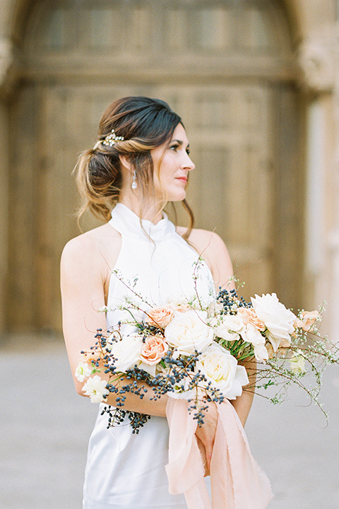  bride in a white gown with a high neckline and gold headpiece 