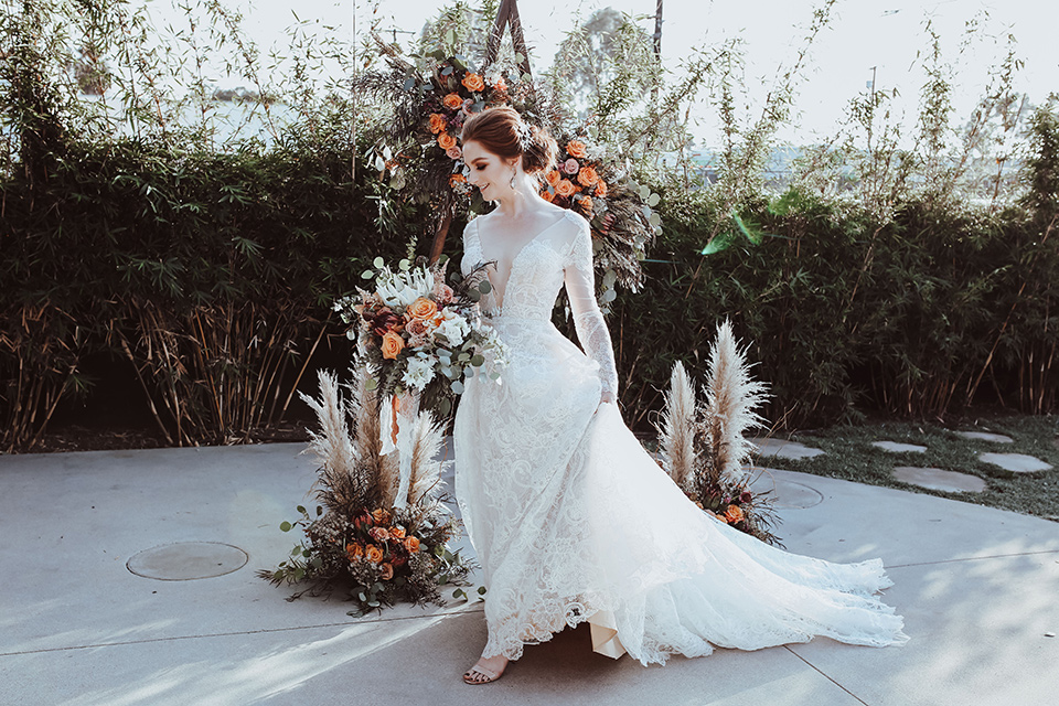 bride in a white gown with a flowing skirt and a lace high neck gown