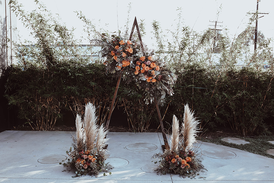 geometric arch with pampas grass and boho style flowers 