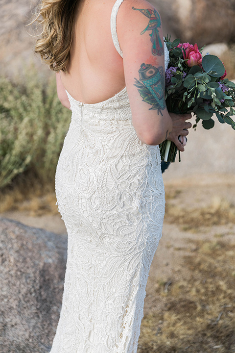  bride in a white lace bohemian style gown with a sweetheart neckline and thin straps