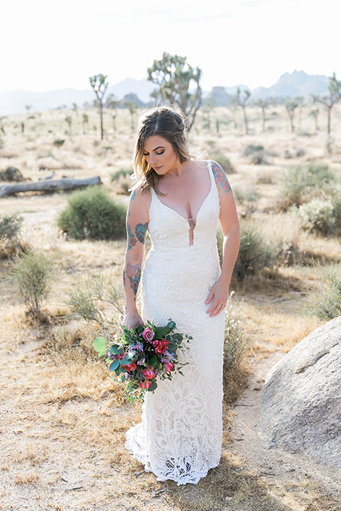  bride in a white lace bohemian style gown with a sweetheart neckline and thin straps 