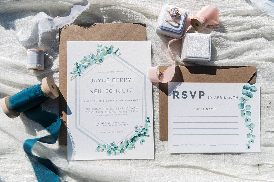  white invitations with sage details