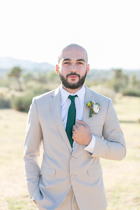  groom in a tan notch lapel with a teal long tie