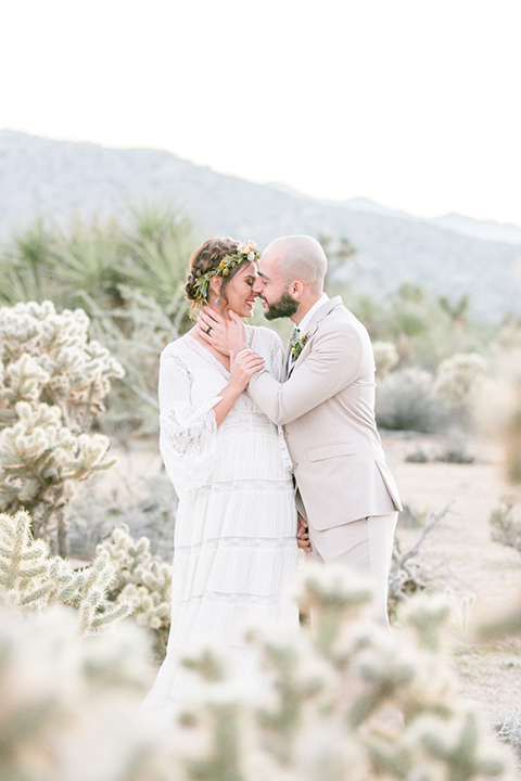  bride in a bohemian style gown with lace and a floral crown and a jean jacket 