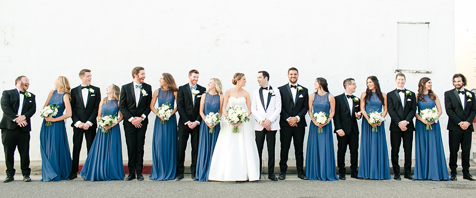  dusty-blue-bridesmaids-gowns-with-the-groomsmen-in-black-tuxedos