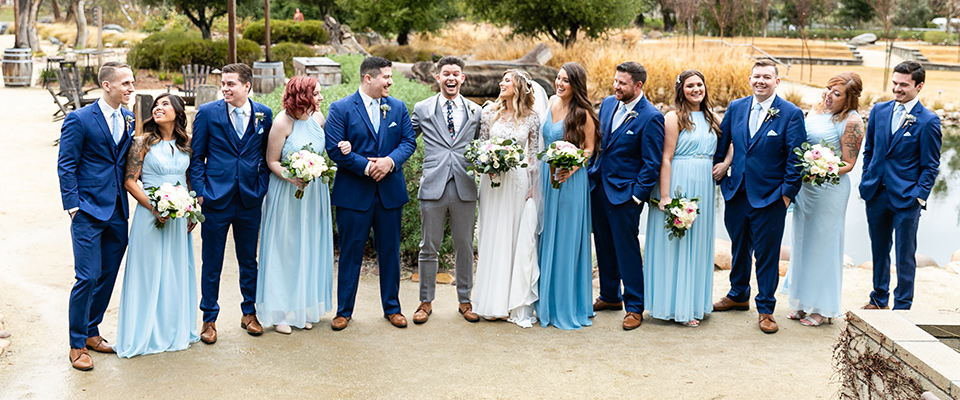  teal-blue-bridesmaids-gowns-with-blue-suits-for-groomsmen-and-grey-suit-for-the-groom