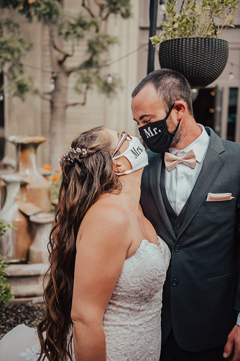  bride in a formfitting white lace gown with a long train 