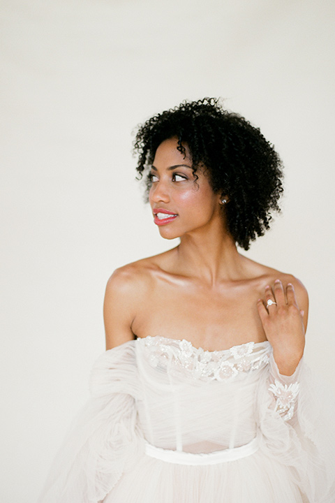  bride in a tulle ballgown with an off the shoulder detail and full billowed sleeves 