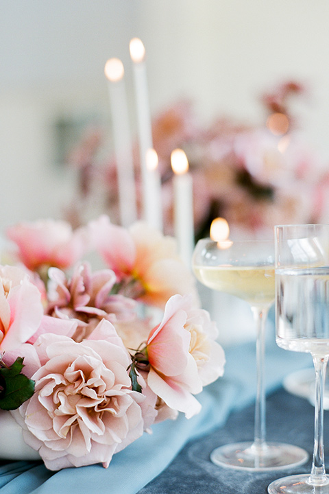  dusty blue linens with tall candles and blush toned florals