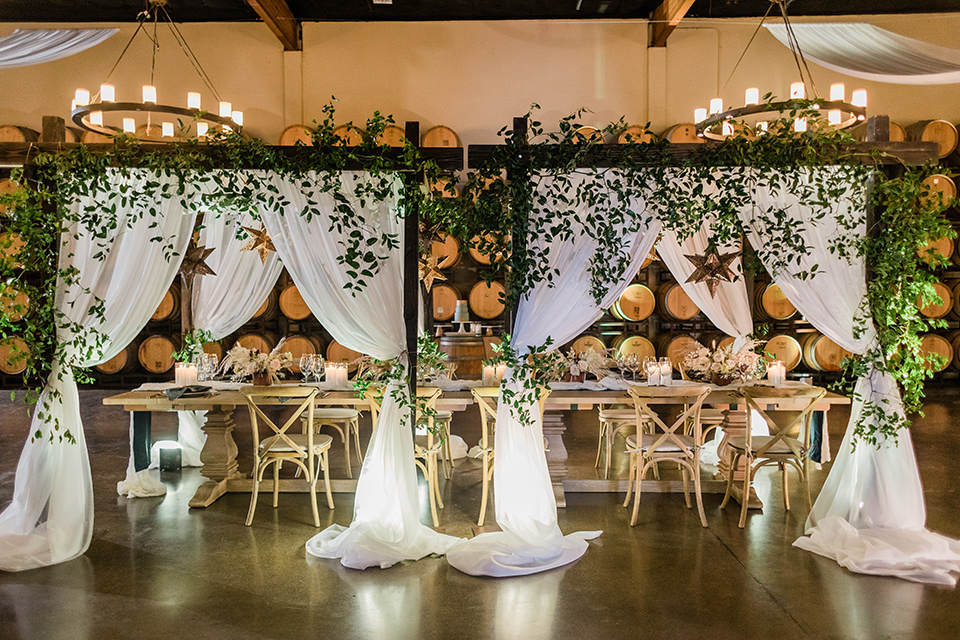 bohemian winery wedding details with long white curtains and greenery 